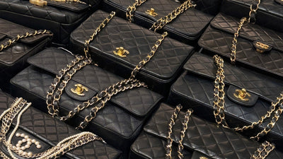 Black Chanel Classic Flap bags with gold CC turn-locks and chain straps.