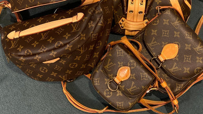 Several Louis Vuitton crossbody bags in Monogram canvas laid out together.