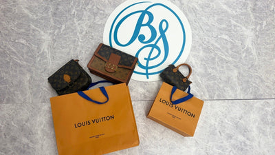 Pre-loved Louis Vuitton bags and orange shopping bags beside the Brand Street Tokyo logo.