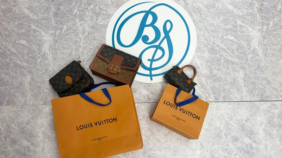 Pre-loved Louis Vuitton bags and orange shopping bags beside the Brand Street Tokyo logo.