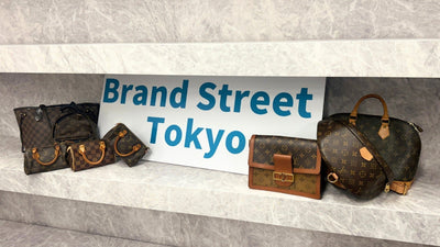 Pre-loved Louis Vuitton bags displayed beside a Brand Street Tokyo sign.