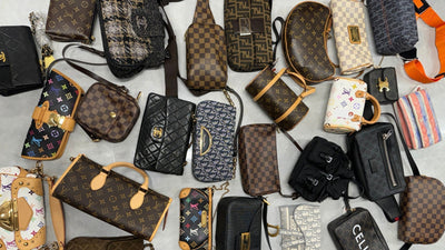 Vintage designer bags from Louis Vuitton, Fendi, Dior, Chanel, and Celine laid out on a table.